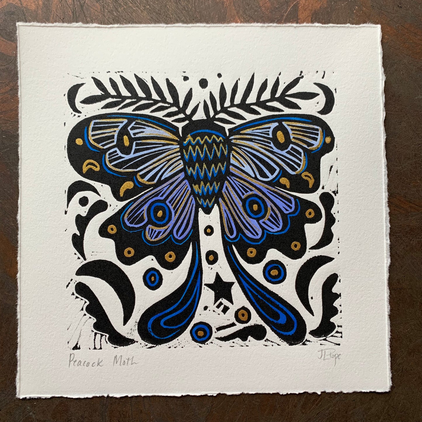 Handpainted blue moth linocut