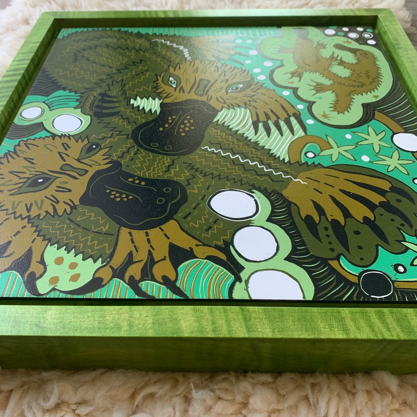 Platypus woodcut framed in green