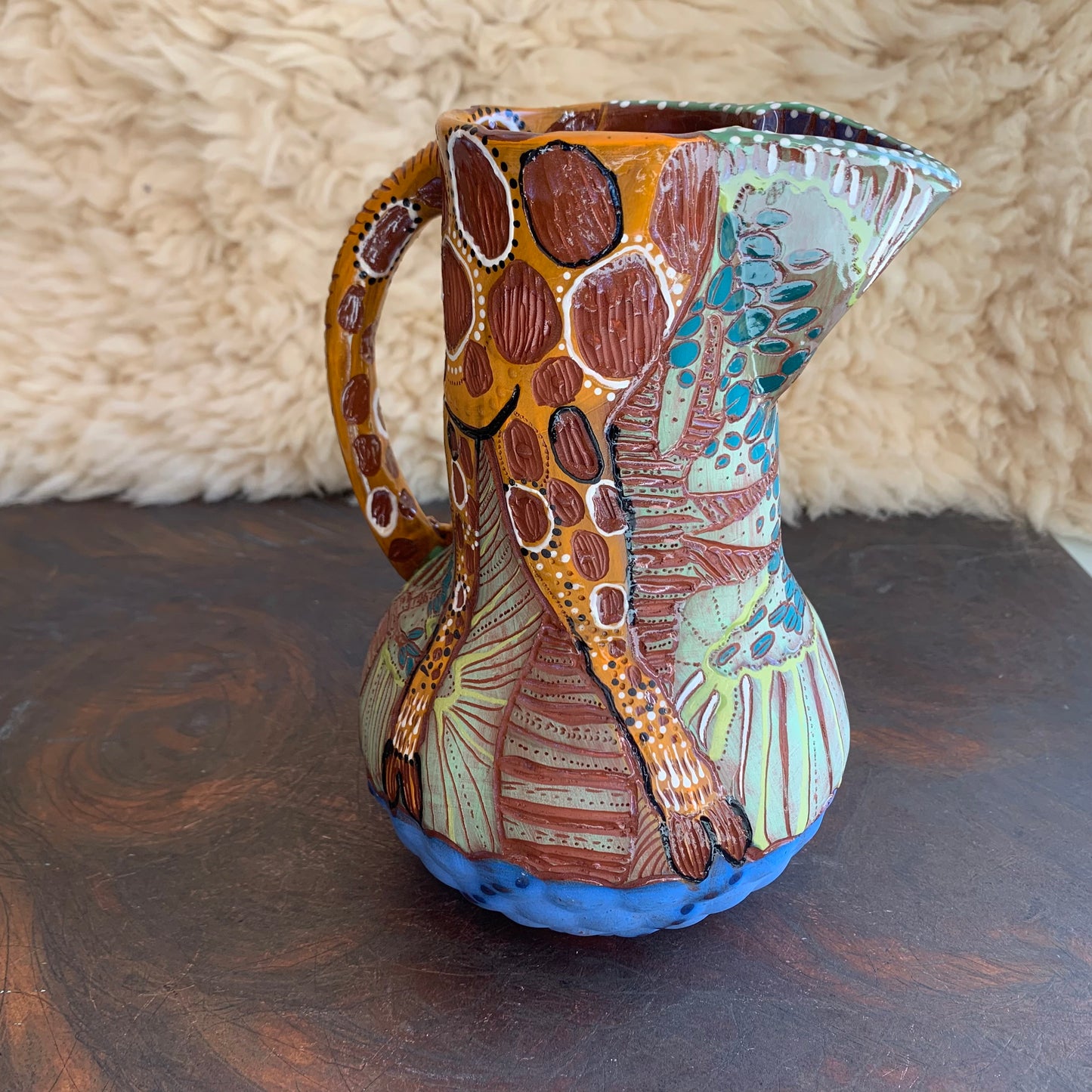 Giraffe pitcher with baobab trees