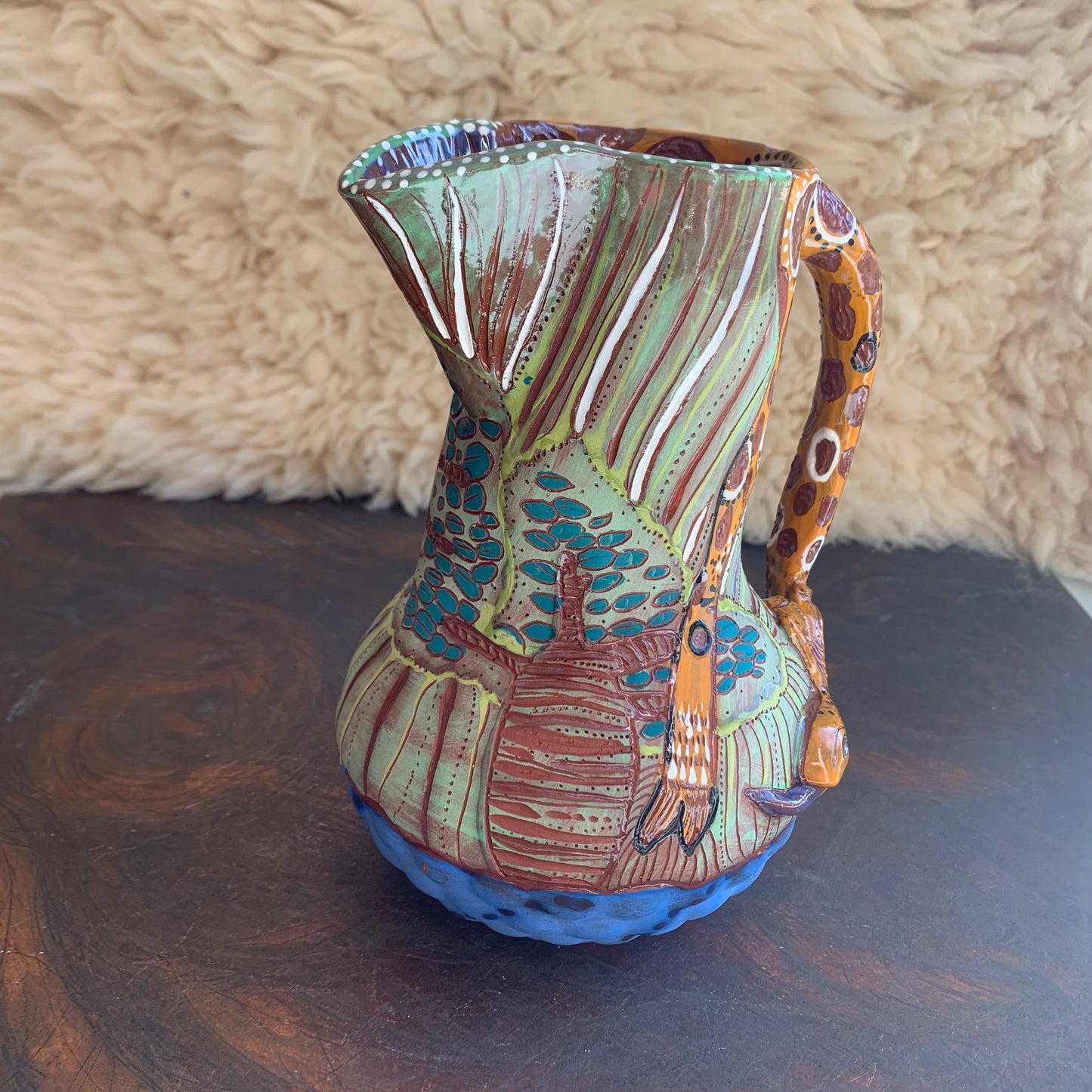 Giraffe pitcher with baobab trees