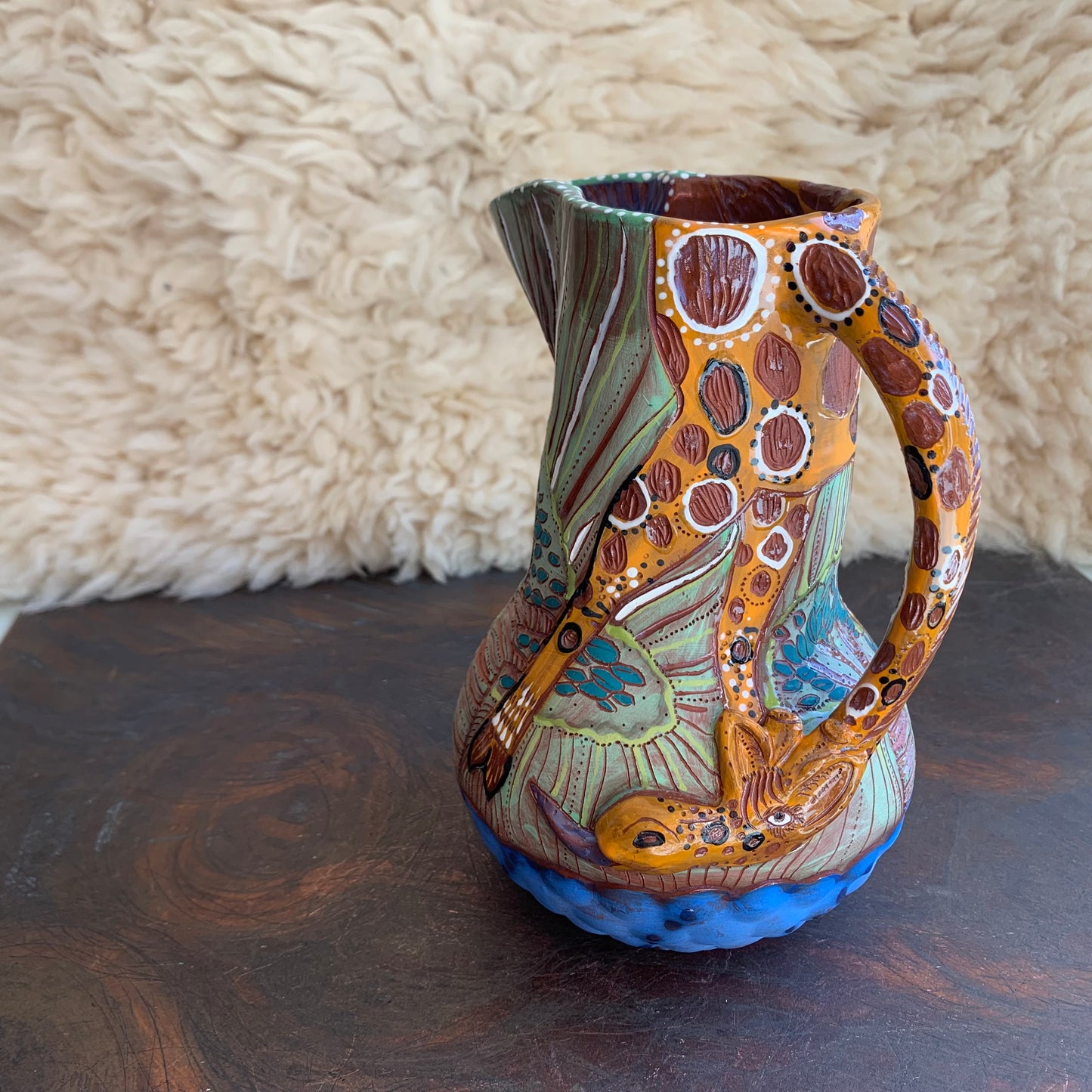 Giraffe pitcher with baobab trees