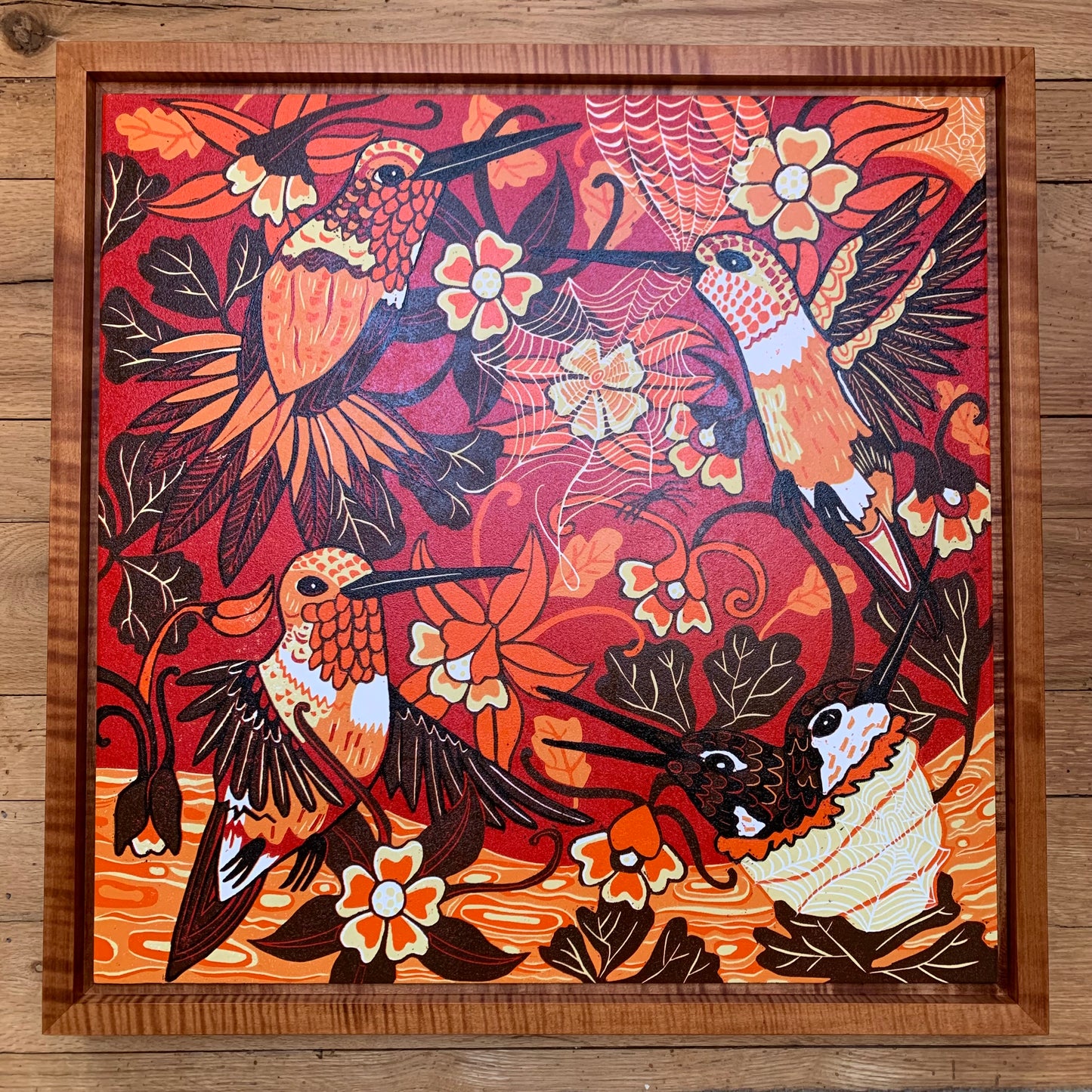 Hummingbird and spiderweb woodcut framed in nutmeg