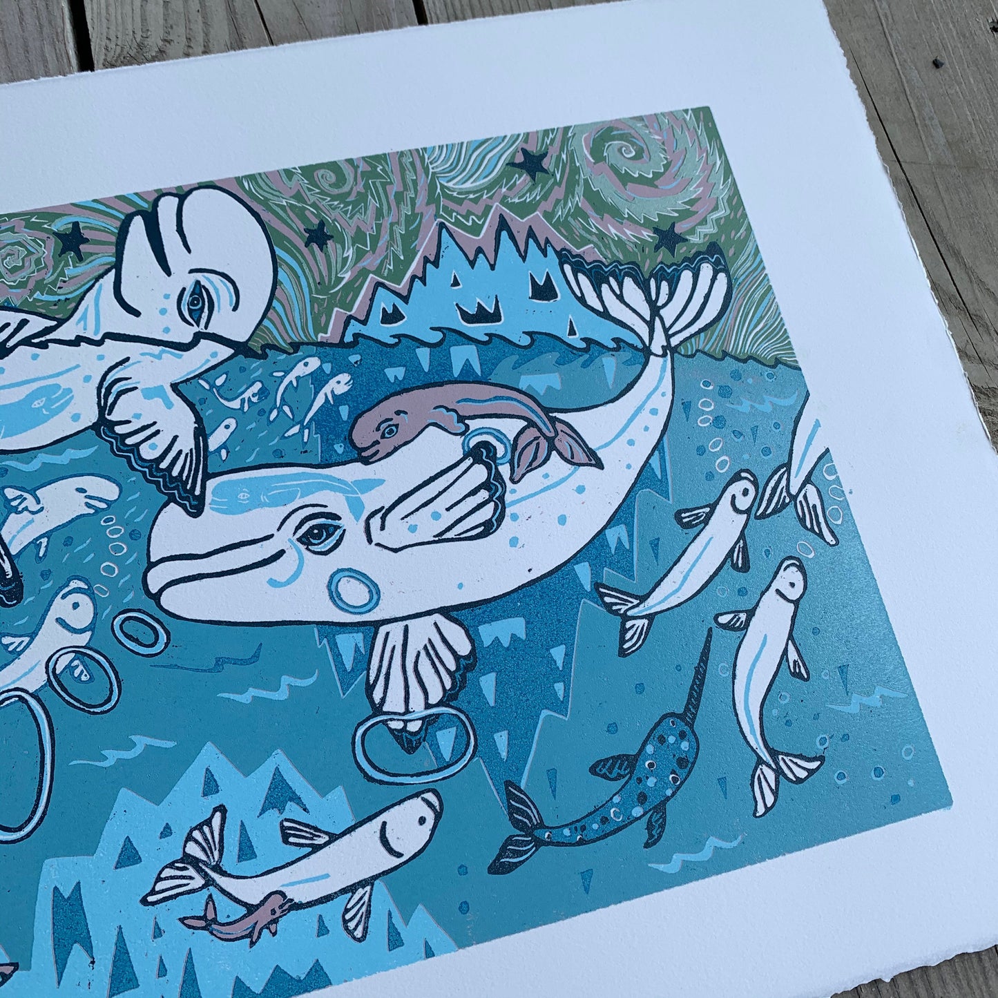 Beluga woodcut with little whales in the big whales